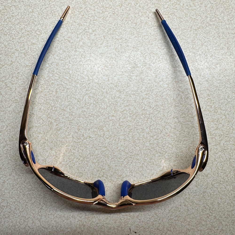 Polarized Sunglasses with blue lenses and ear cushions. Peach metal frames, New